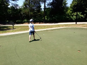 Practicing his putting game